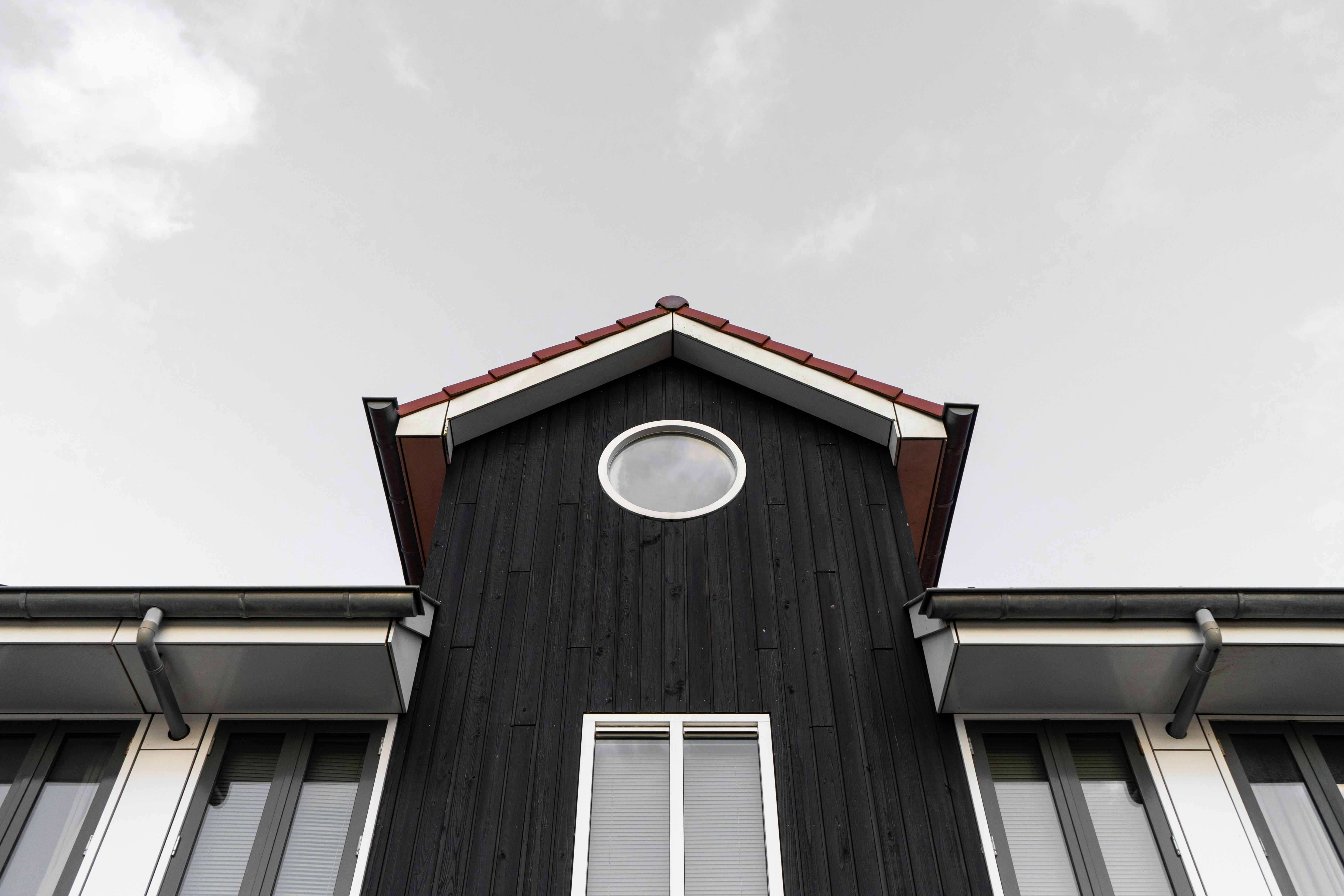 white and black wooden house under white sky during daytime